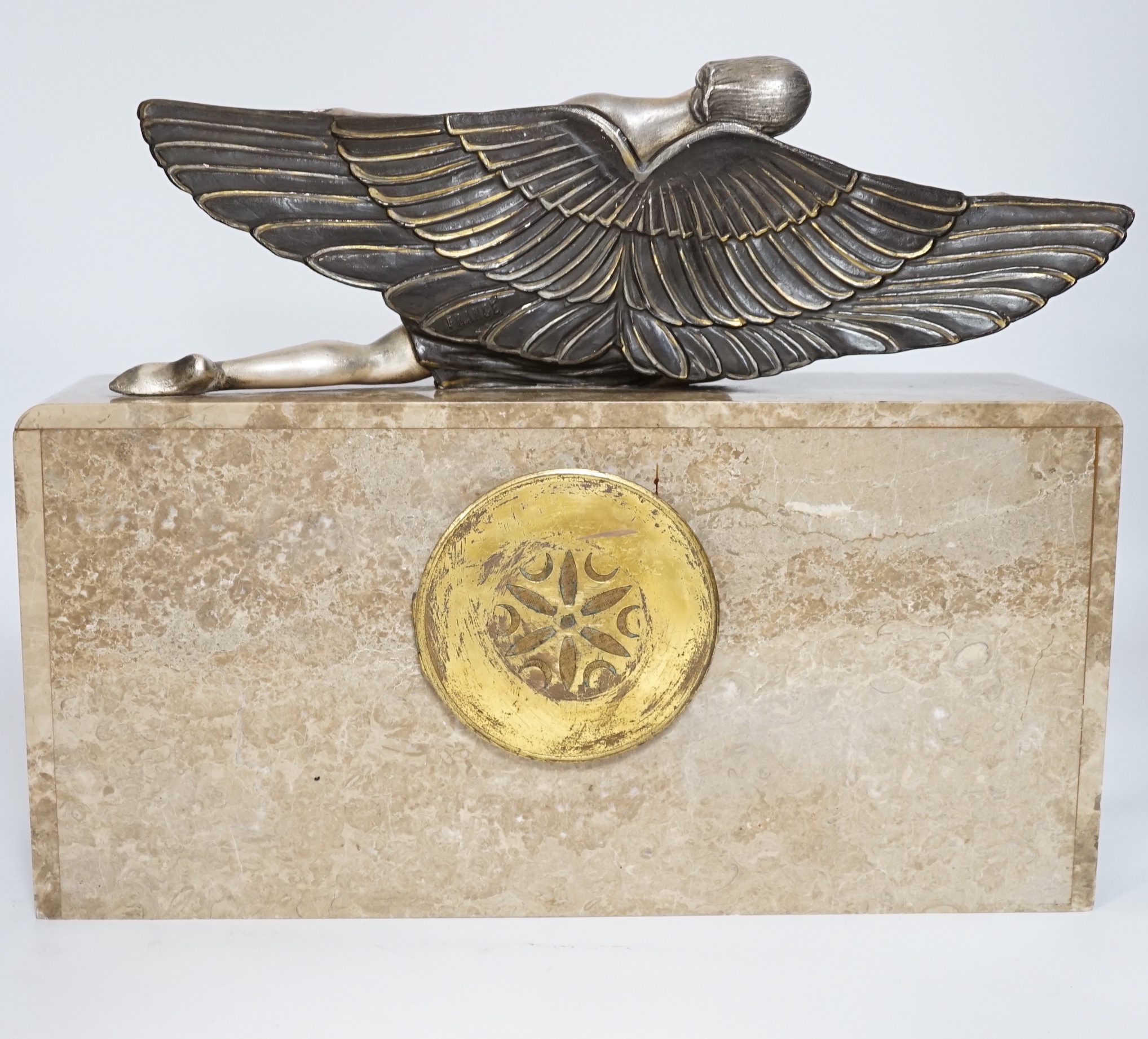 An Art Deco marble mantel clock with a metal winged woman, with French pendulum movement striking on a bell, 38cm wide, 30cm high